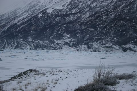 2003 Jeep TJ - A vast, icy landscape under a cloudy sky, with a frozen lake in the foreground and a massive glacier on the mountain.