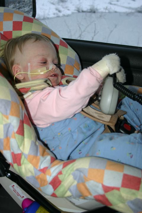 2003 Jeep TJ - Interior view of a child in a car seat, with medical equipment attached.