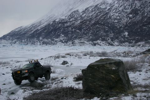 2003 Jeep TJ - A pickup truck navigates a snowy landscape with a glacier and mountains visible.