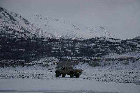 2003 Jeep TJ - A pickup truck sits in a snowy landscape with mountains behind it.