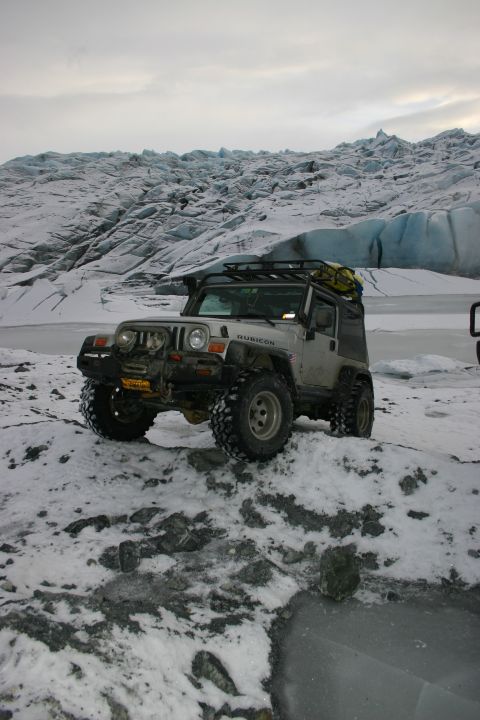2003 Jeep TJ - Silver 2003 Jeep TJ Rubicon navigates snowy terrain near a glacier.