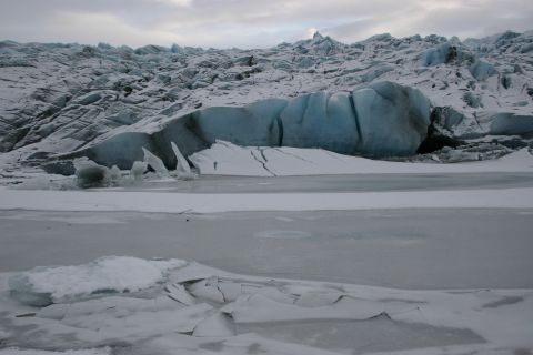 2003 Jeep TJ - A vast glacier landscape under a cloudy sky, with fractured ice in the foreground and a body of frozen water.