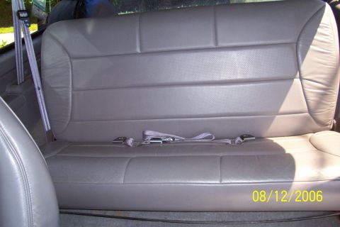 1995 Ford Bronco - The rear seat of a vehicle is shown, complete with seatbelts and a date stamp from 2006.