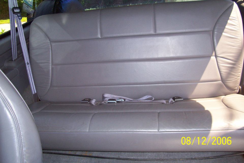 Back seat with gray leather upholstery and seatbelts. Date stamp shows 08/12/2006