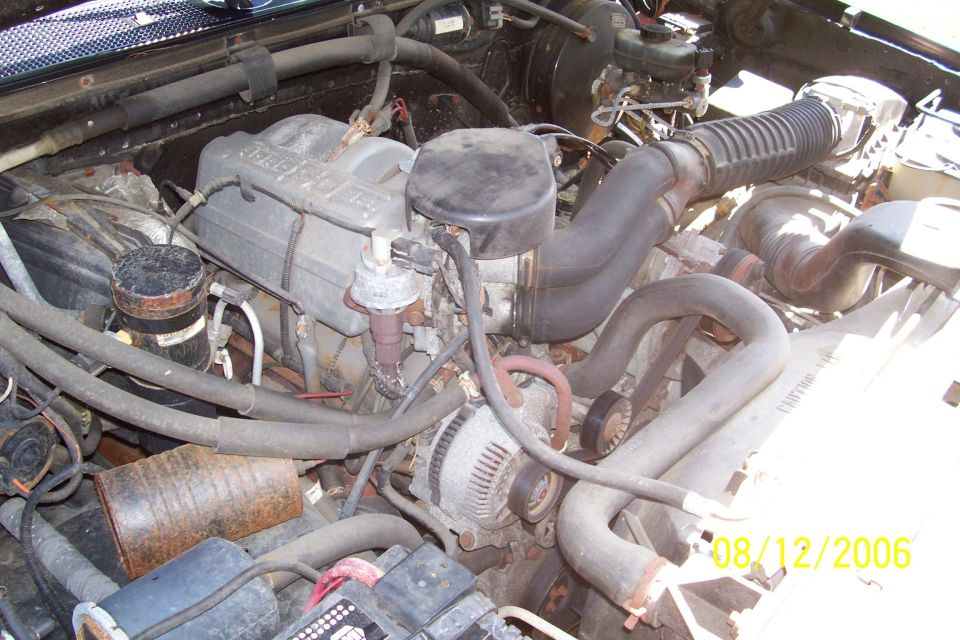 1995 Ford Bronco engine bay with V8 engine, alternator, and air intake system
