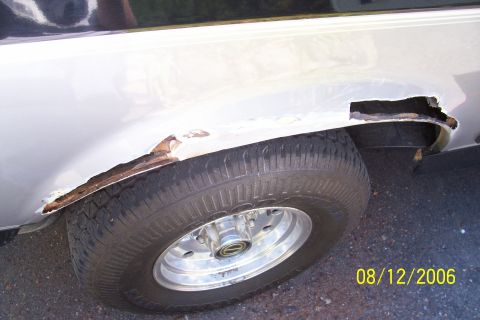 1995 Ford Bronco - Severe rust damage is visible on the rear wheel well of this vehicle.