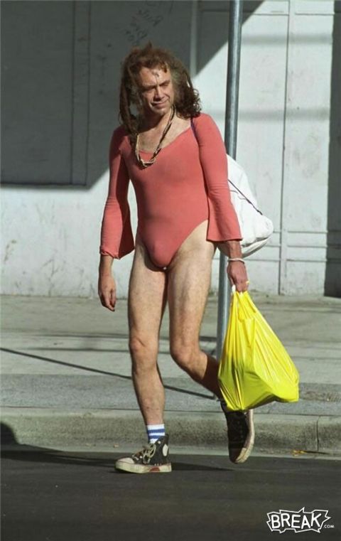 1991 Ford Bronco - A person in a pink leotard and carrying shopping bags walks down a street.
