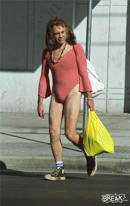 Person in pink leotard walks with yellow and white bags