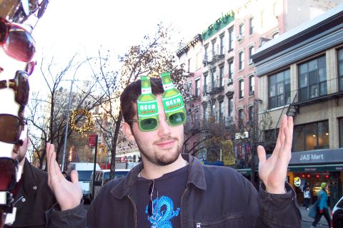 2001 Ford Crown Victoria - A man poses for a photo while wearing novelty beer goggles on a city street.
