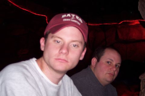 2001 Ford Crown Victoria - Two men are pictured in a dark setting, with red lights visible in the background.