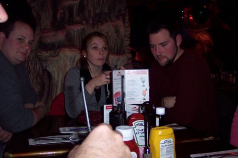 2001 Ford Crown Victoria - People are seated at a table in a restaurant, with condiments and a menu visible.