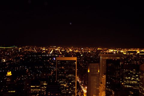 2001 Ford Crown Victoria - View of the New York City skyline illuminated at night, with lights stretching to the horizon.