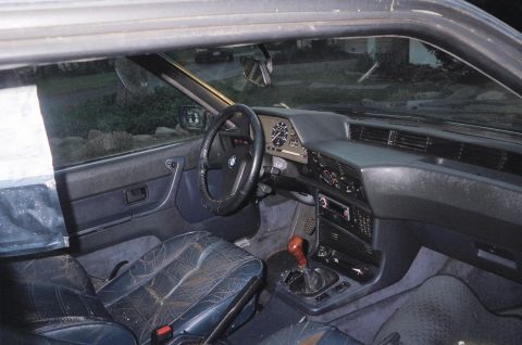 1983 BMW 5 Series - The interior of a BMW E24 6 Series coupe shows signs of wear and tear on the seats and dashboard.