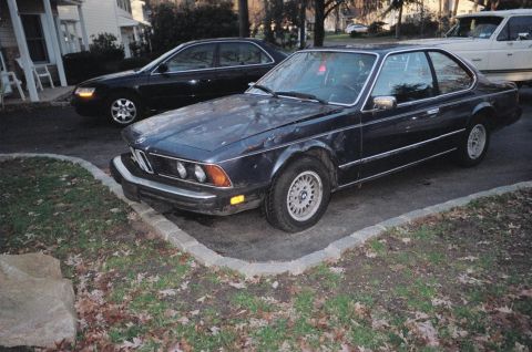 1983 BMW 5 Series - BMW E24 coupe, likely a late 1980s model, parked in a driveway with other vehicles.