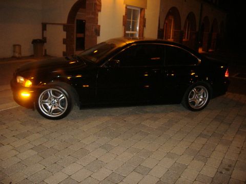 2001 BMW 3 Series - Side view of a black 2001 BMW 3 Series coupe parked on brick pavers.