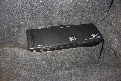 1999 Ford Taurus - A 10-disc CD changer is visible, likely in a car's trunk or storage area.