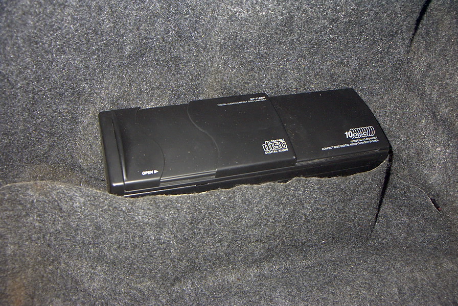 Black 10-disc CD changer with 'DISC' logo and 'COMPACT DISC DIGITAL AUDIO CHANGER SYSTEM' text