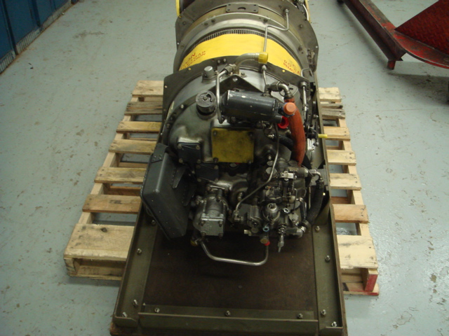 Jet engine on a wooden pallet, with yellow warning labels visible