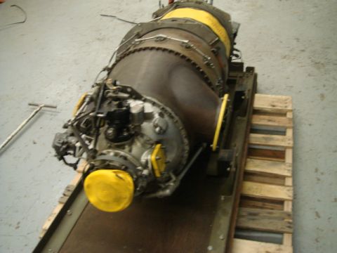 1996 Ford Bronco - A large jet engine is mounted on a wooden pallet, showing complex mechanical components and yellow protective covers.