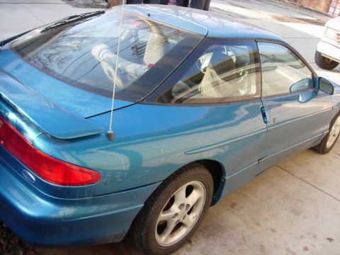1994 Ford Probe - This blue 1994 Ford Probe is shown from the rear quarter angle, highlighting its sporty design.