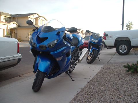 2007 Kawasaki Ninja - Two blue Kawasaki Ninja motorcycles are parked on a driveway next to a white pickup truck.