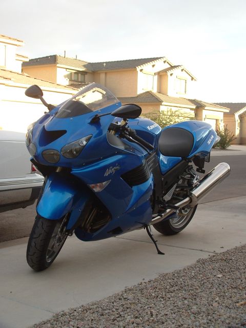 2007 Kawasaki Ninja - Blue 2007 Kawasaki Ninja motorcycle parked on a driveway with houses in the background.