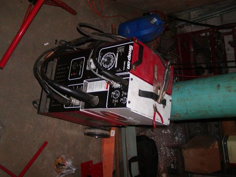 1991 Ford Bronco - A red and black Snap-on welding machine is shown with various cables and tools.