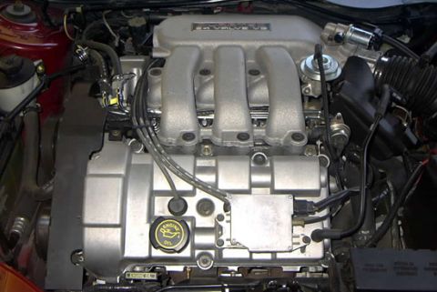 1999 Ford Taurus - Close-up view of an engine compartment, showing the intake manifold and valve cover.