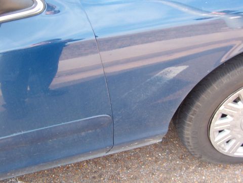 1999 Ford Crown Victoria - This fender is pushed back against the passenger door. It also carried the hood back on this side.