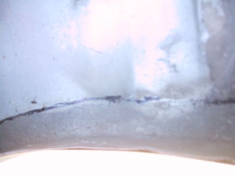 1994 Ford Bronco - A close-up view of a metal panel with a visible seam and markings.