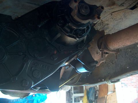 1991 Ford Bronco - Underside view of a vehicle's transmission and exhaust system components.