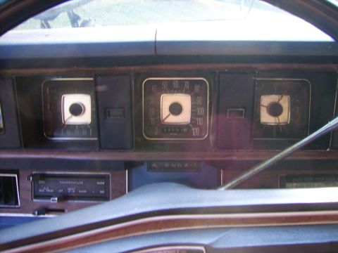 1971 Mercury Marquis - The dashboard features a speedometer, temperature gauge, and radio with visible text.