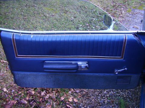 1971 Mercury Marquis - Interior door panel of a 1971 Mercury Marquis, showing blue vinyl upholstery and chrome accents.