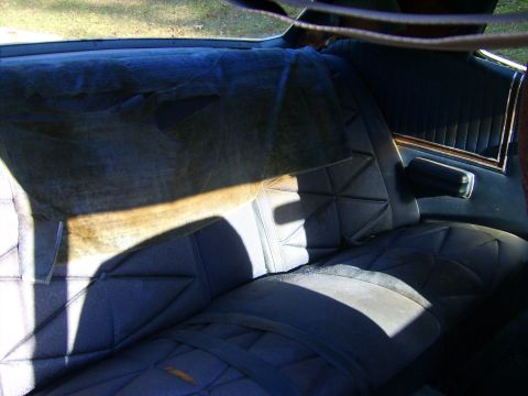 1971 Mercury Marquis - The interior of a car shows worn rear seats and a fabric headliner.