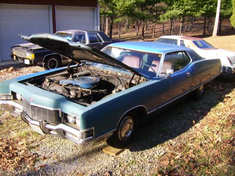 1971 Mercury Marquis - A blue 1971 Mercury Marquis coupe sits in a gravel driveway with its hood open, alongside other vehicles.