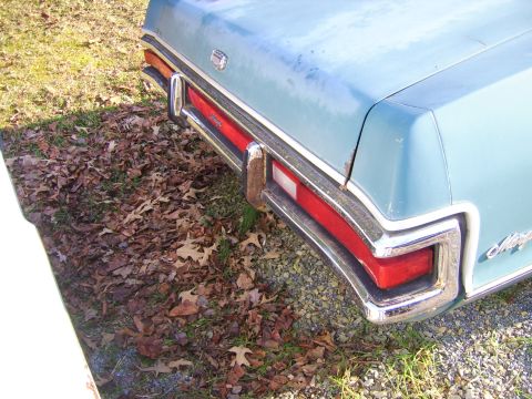 1971 Mercury Marquis - The rear of a classic light blue sedan, showing its distinctive taillight and bumper design.