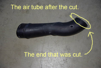 1999 Ford Taurus - The air intake tube shows a clean cut at one end, indicating modification or repair.