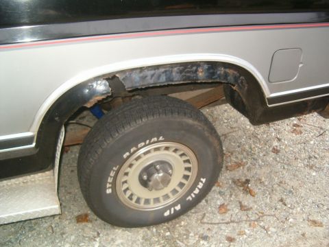 1986 Ford Bronco - The rear wheel well shows significant rust damage, obscuring any specific year identification.