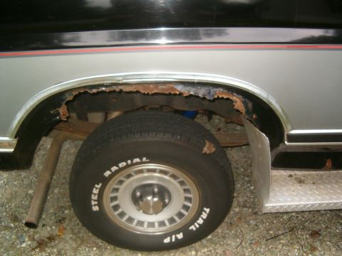 1986 Ford Bronco - The rear wheel well of a 1986 Ford Bronco shows significant rust damage.