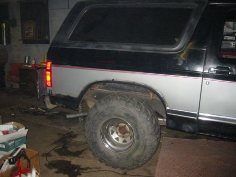 1986 Ford Bronco - This Ford Bronco is undergoing some work in a garage setting, with its rear brake light on.