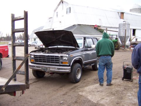 1978 Ford Bronco - 1978 Ford Bronco with hood open, parked on a dirt lot near a barn.