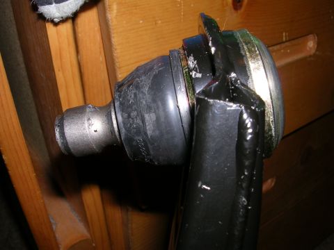 1996 Ford Probe - Close-up of an automotive ball joint, showing a rubber boot and metal components.