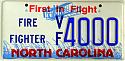 1998 Ford Crown Victoria - This North Carolina license plate displays 'First in Flight' and 'Fire Fighter' with the number VF 4000.