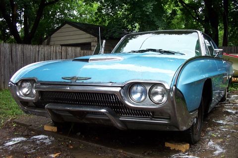 1978 Ford Bronco - Front view of a light blue 1961 Ford Thunderbird convertible parked outdoors.