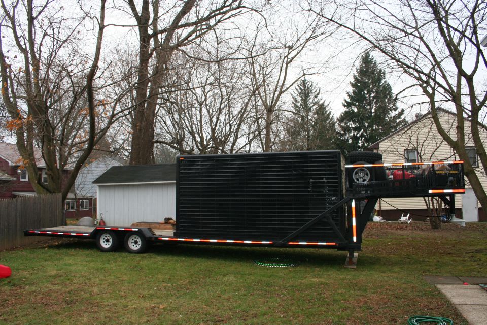 Black enclosed trailer with flatbed, side view