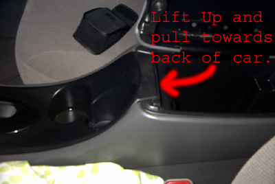 1999 Ford Taurus - Close-up of car interior center console with instructions for removal.