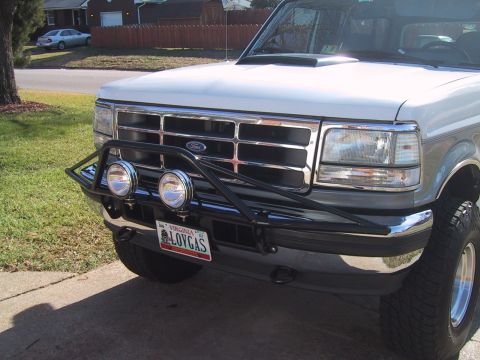 1994 Ford Bronco - 1994 Ford Bronco front view, showing the grille and custom bumper with lights. The license plate is visible.