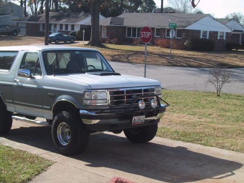 1994 Ford Bronco - This Ford Bronco, likely from the early to mid-1990s, is shown with a custom front bumper and fog lights.