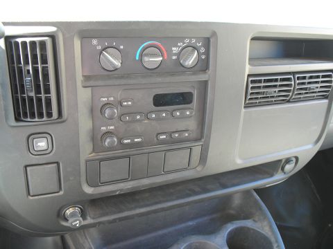 2005 Chevrolet Express - Close-up view of the dashboard controls and center console of a van.