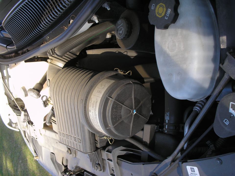 GM Vortec air cleaner housing and brake fluid reservoir in an engine bay